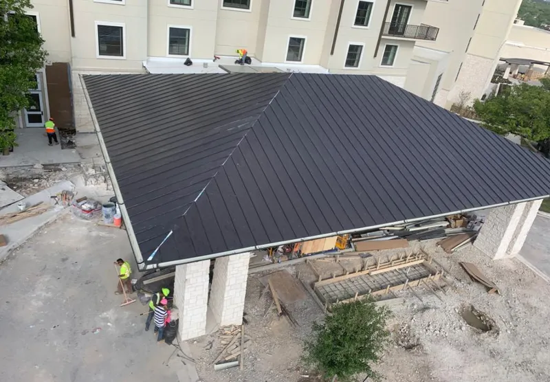 Metal roofing installation team working on a commercial building in Brawley